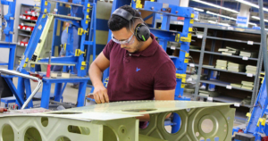 A worker assembles a part that will become a wing of a Piper Aircraft plane made in Vero Beach