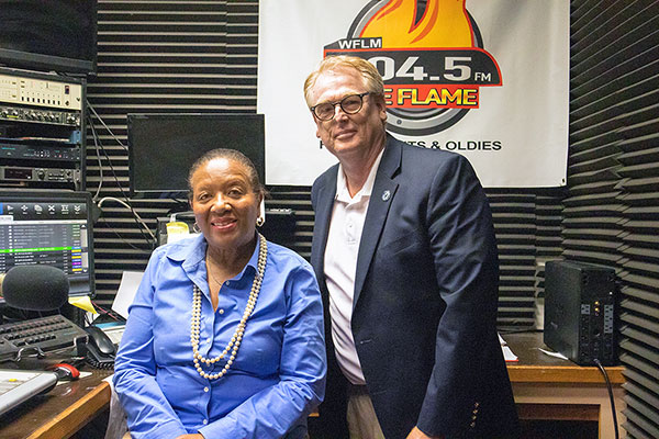 Tom Kindred with Alice E. Lee, president/general manager of WFLM 104.5.