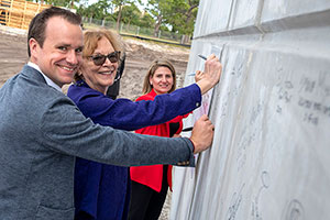 Michael Rem of JBL Development, left, Fort Pierce Mayor Linda Hudson and Sandra Pabon of Itasca Construction Partners sign the cornerstone of the Interstate Commerce Center.