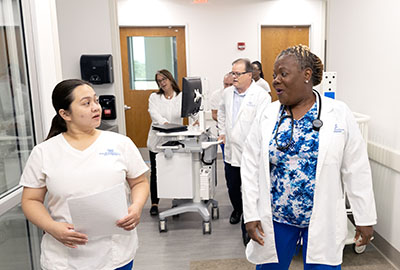 Nursing students often engage in conversations as they go about practicing their duties, much as nurses do in an actual hospital. 