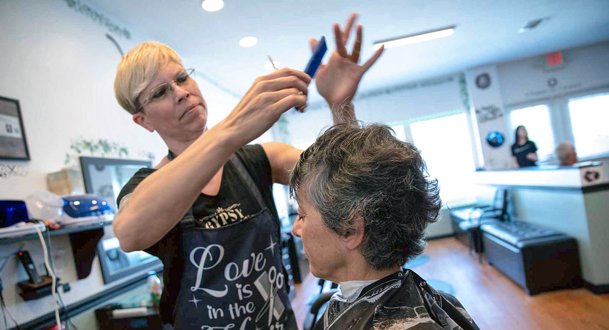 Stylist cutting hair